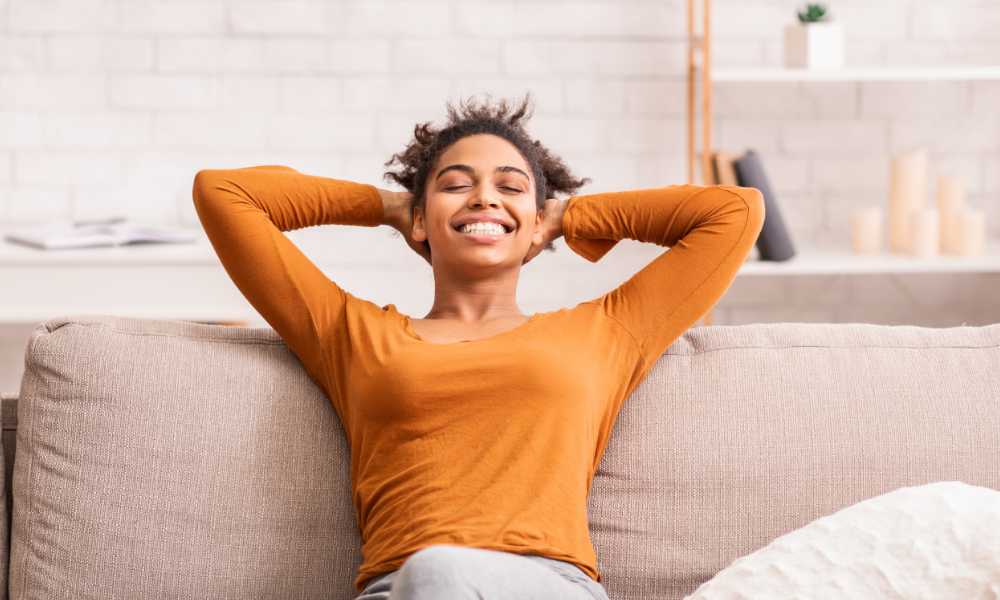 black woman who is very happy on couch