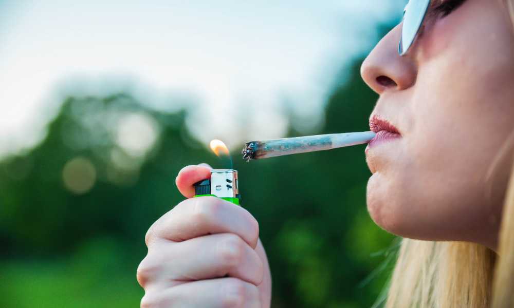 woman lighting cannabis joint