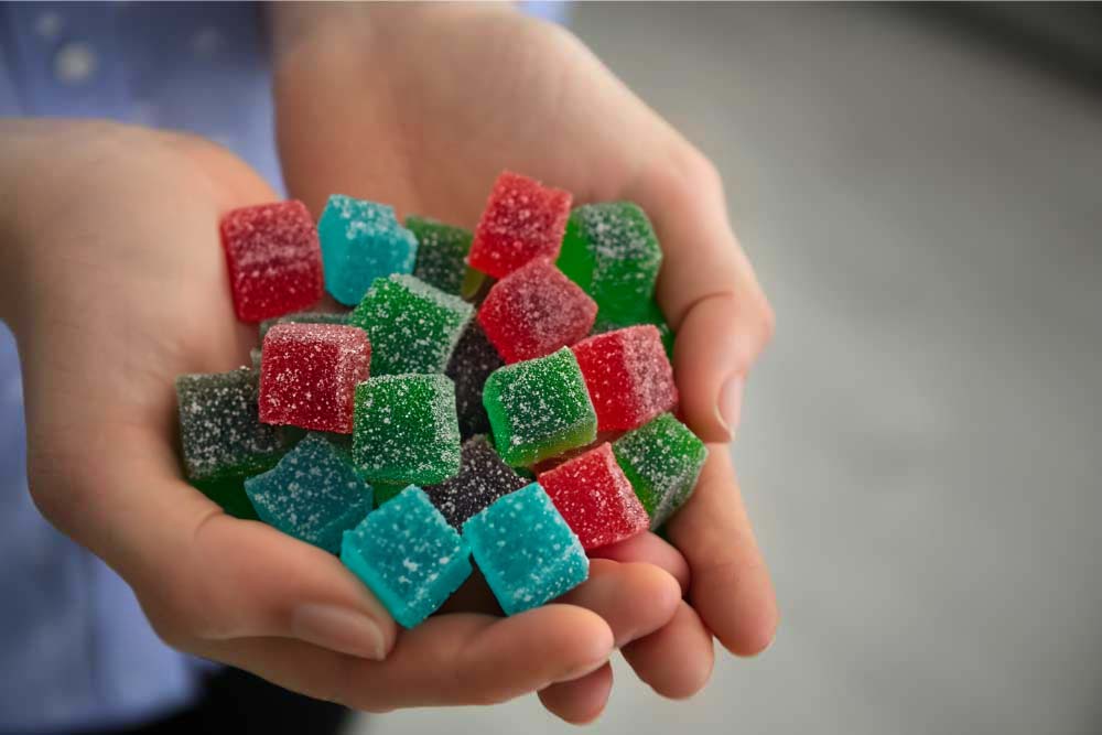 person holding 10 mg gummies