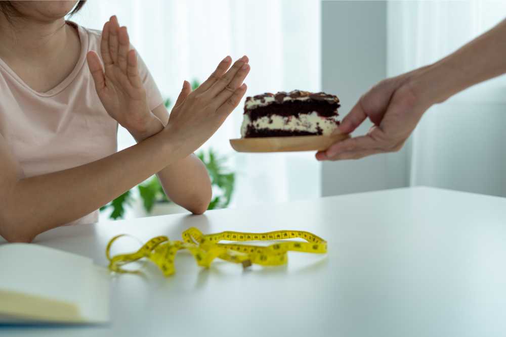 woman saying no to piece of cake