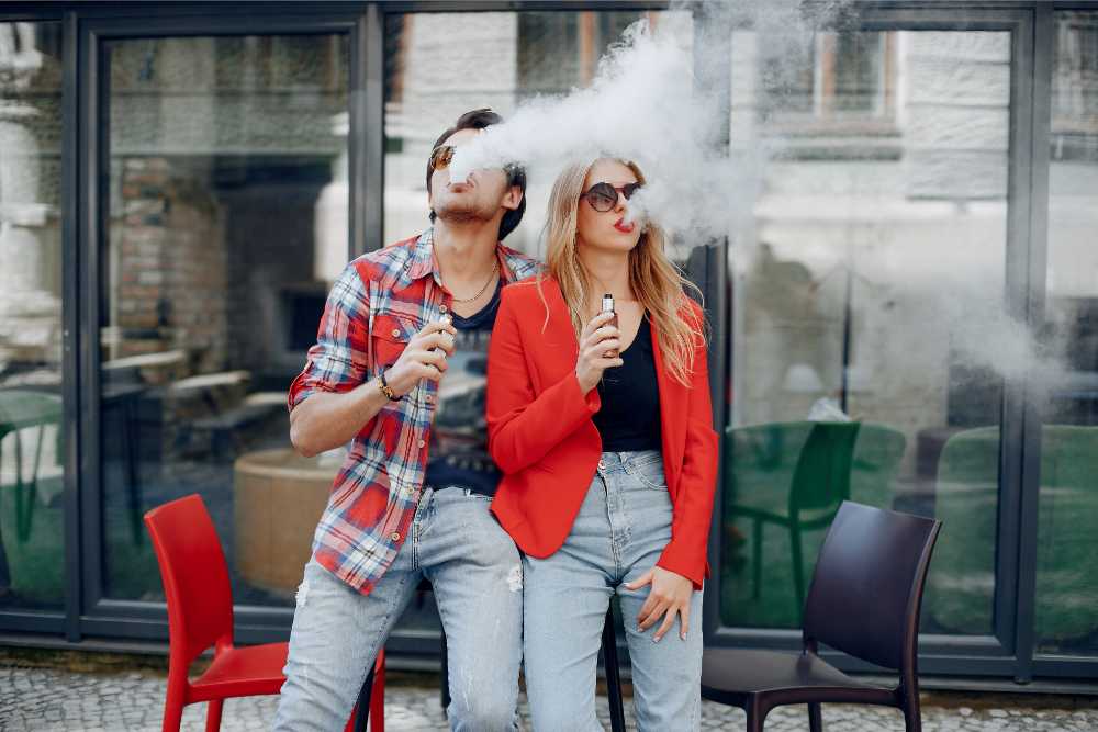 young couple vaping in public