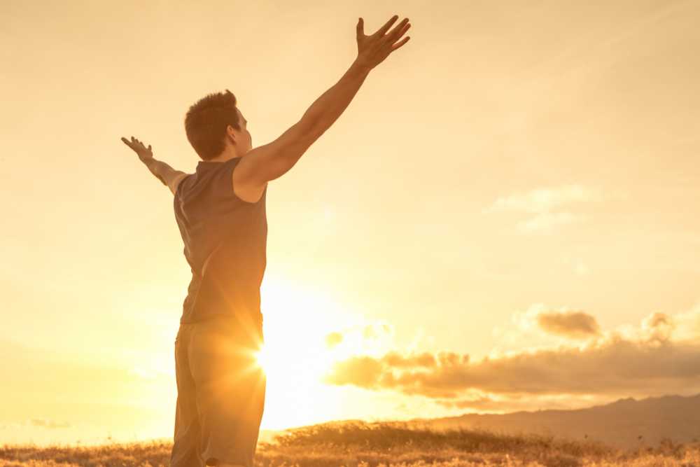 man with outstretched arms during daytime