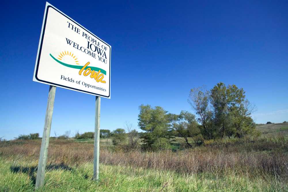 welcome to iowa signs in field