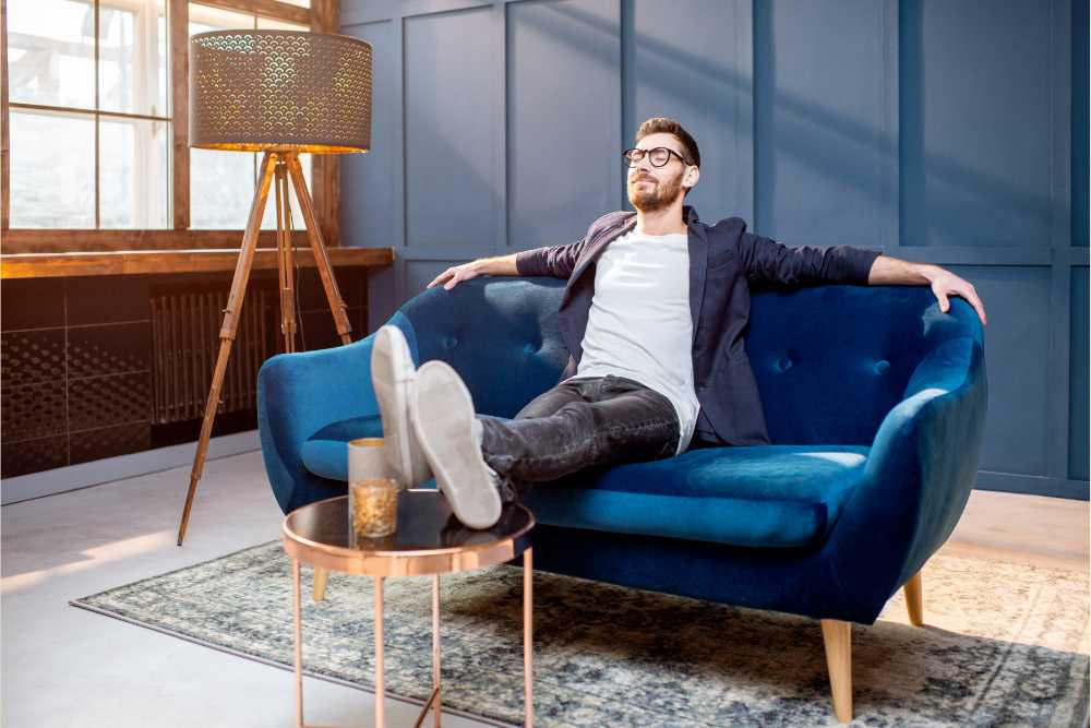 man enjoying the strong effects of thcp on a blue couch