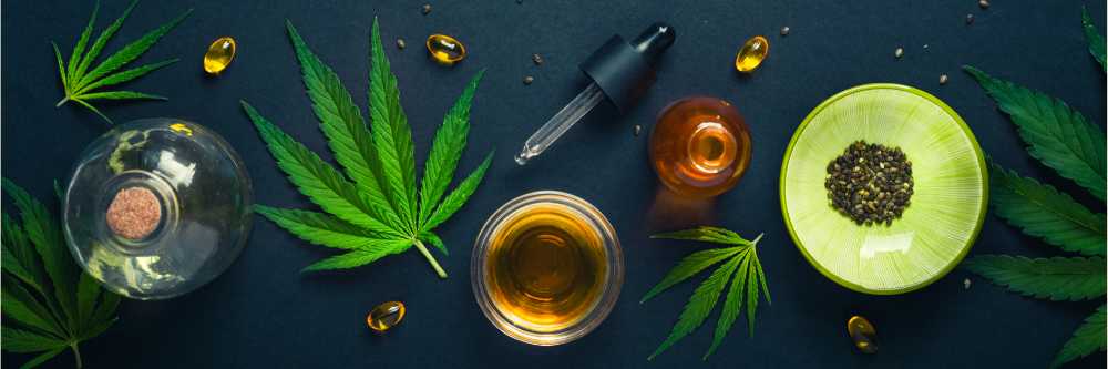 various cannabis products overhead shot on black table