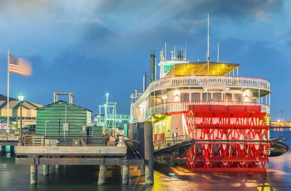 mississippi riverboat on river at dusk