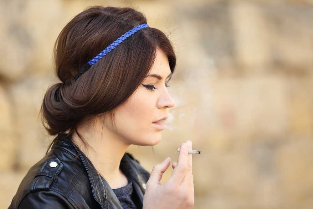 young white brunette woman smoking cannabis joint