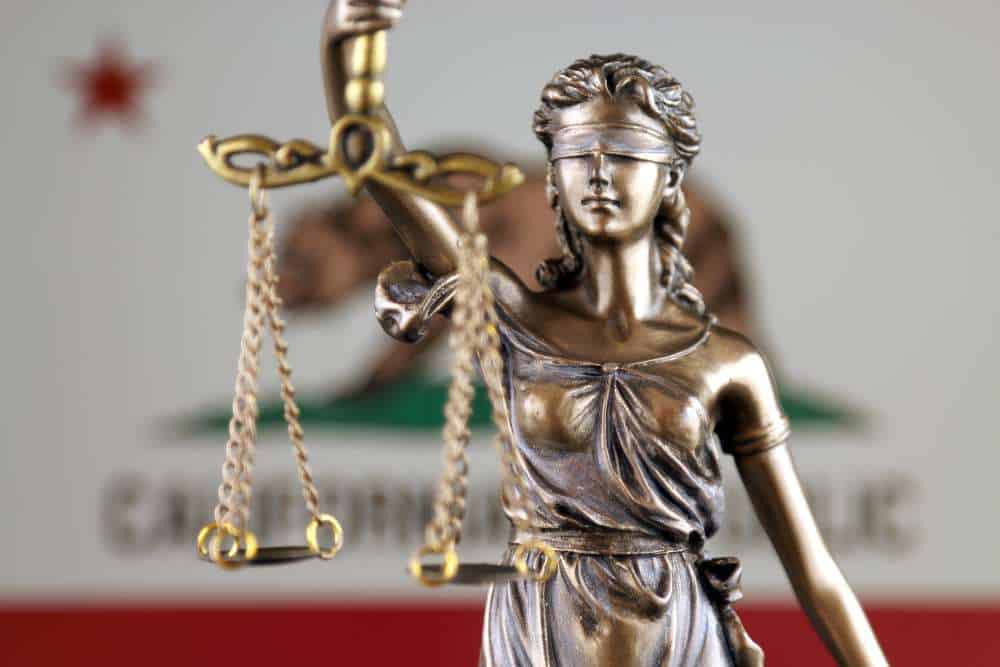 lady justice with california flag in the background