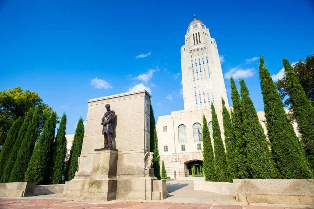 nebraska state capitol building lincoln statue daytime