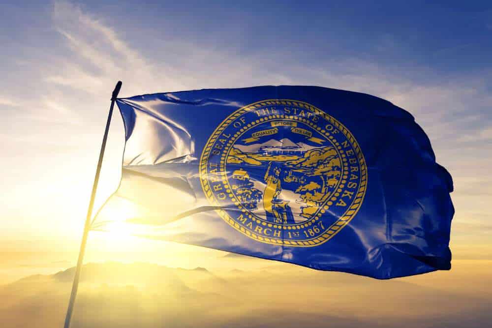 nebraska state flag billowing in the wind at dusk